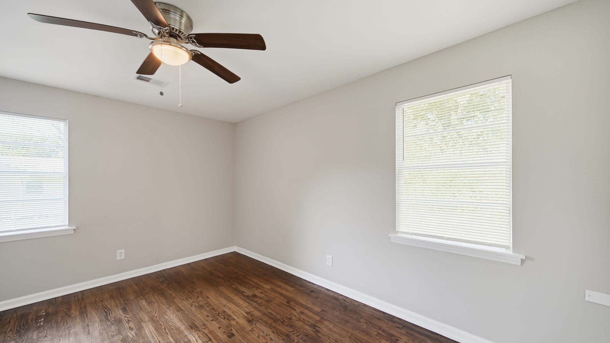 3531 Randolph Street Memphis, TN 38127 - Photo 23 of 32 an empty room with wooden floor fan and windows
