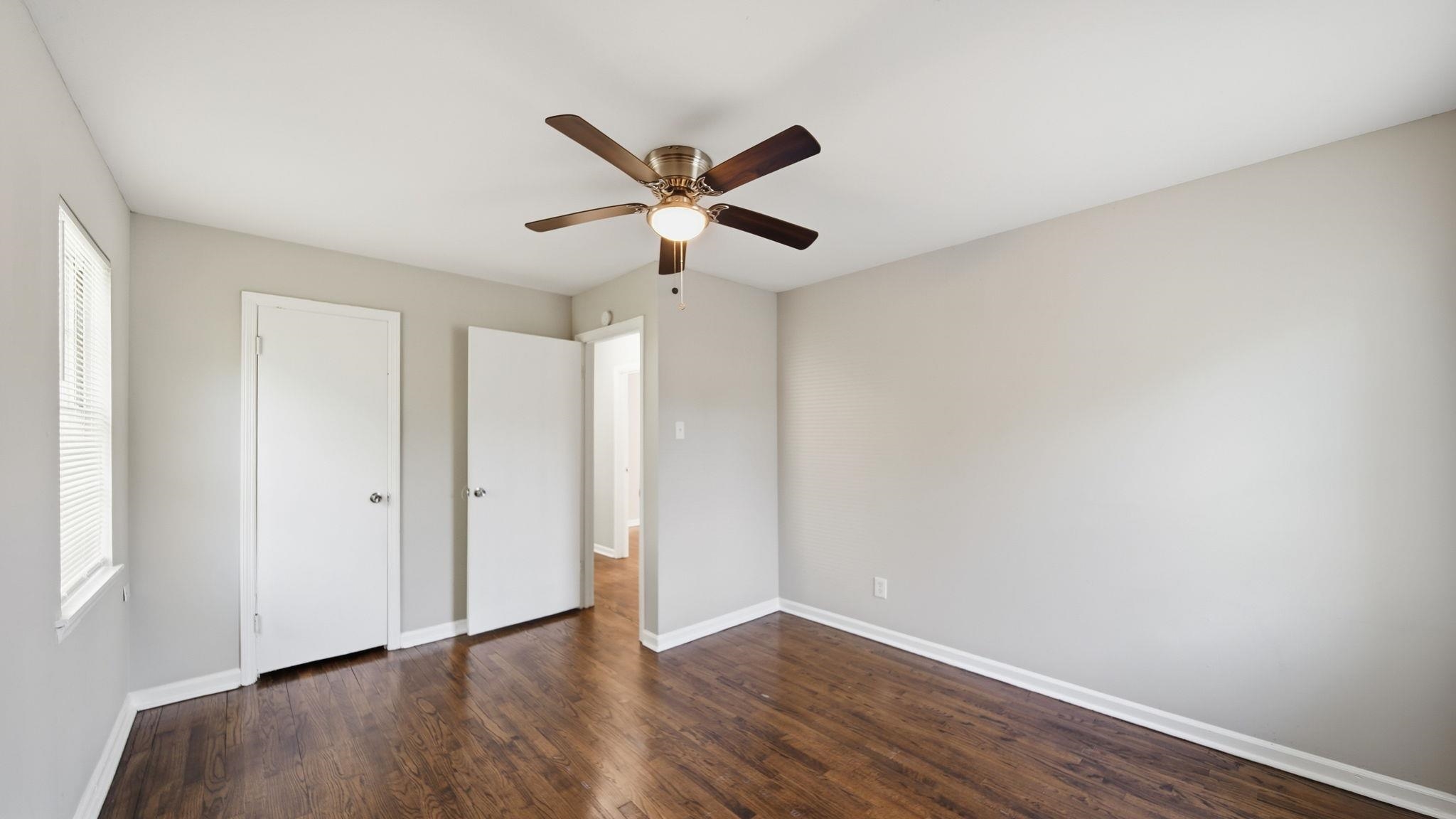 3531 Randolph Street Memphis, TN 38127 - Photo 25 of 32 an empty room with wooden floor ceiling fan and window