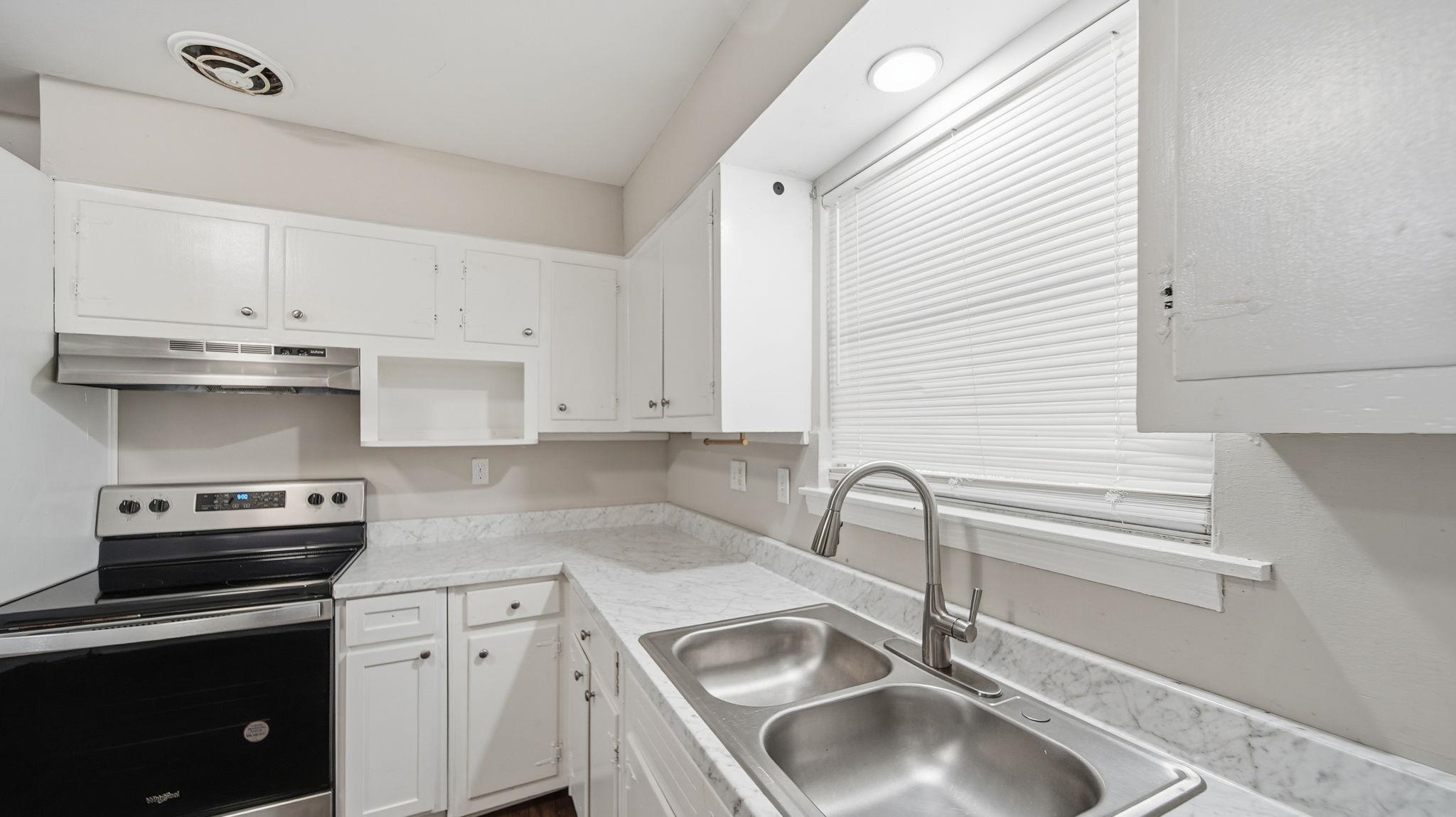 3531 Randolph Street Memphis, TN 38127 - Photo 26 of 32 a kitchen with granite countertop a sink stainless steel appliances and cabinets