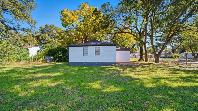 a view of a backyard with large trees