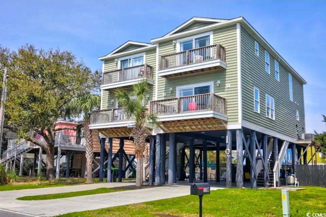 124 B Vista Drive Murrells Inlet, SC 29576 - Photo 1 of 38 View of building exterior with a carport, stairway, and driveway