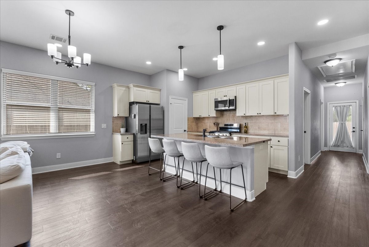 20061 Torrey Pines Lane Cleveland, TX 77327 - Photo 12 of 41 a large white kitchen with lots of counter space a refrigerator and dining table