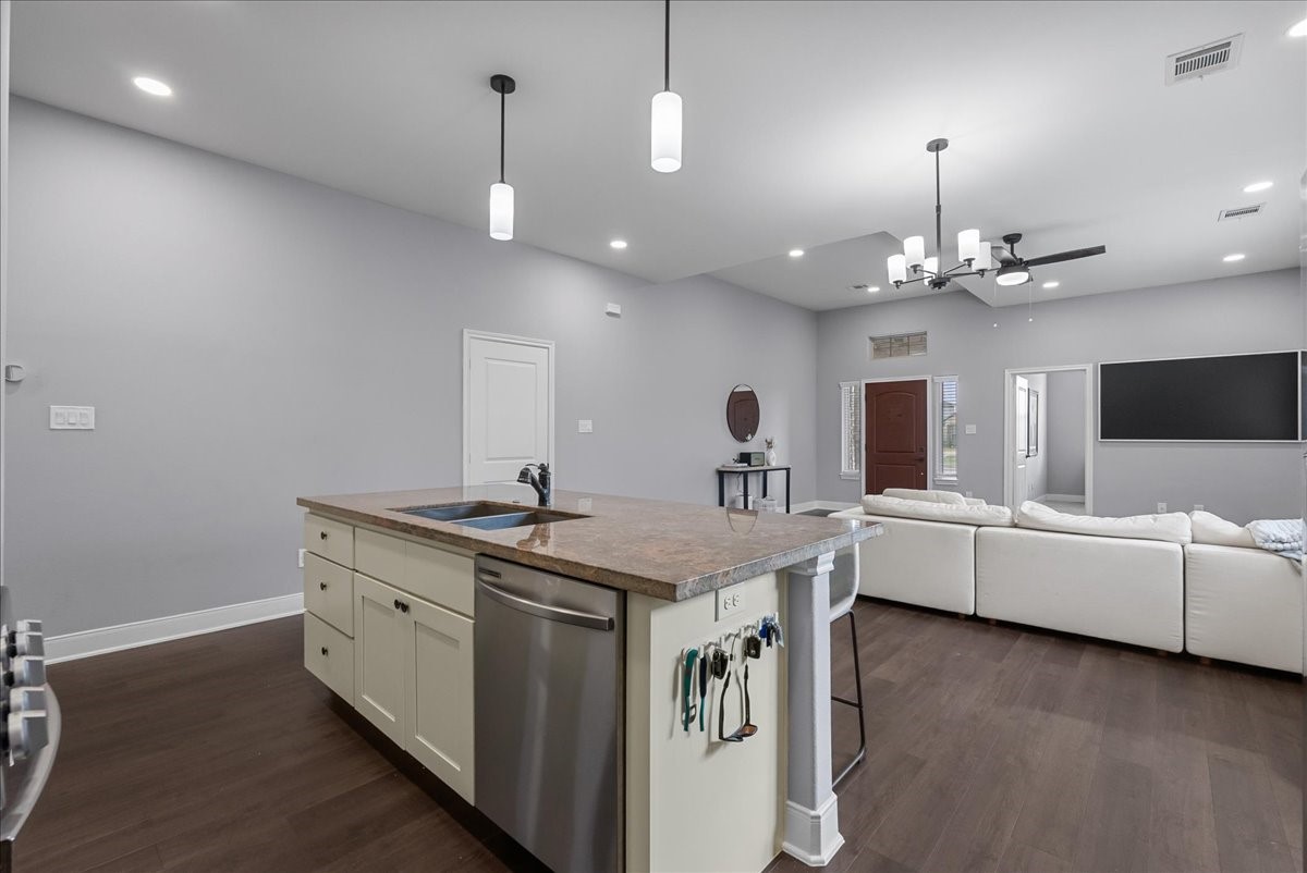 20061 Torrey Pines Lane Cleveland, TX 77327 - Photo 14 of 41 a view of living room with granite countertop furniture a flat screen tv and kitchen view