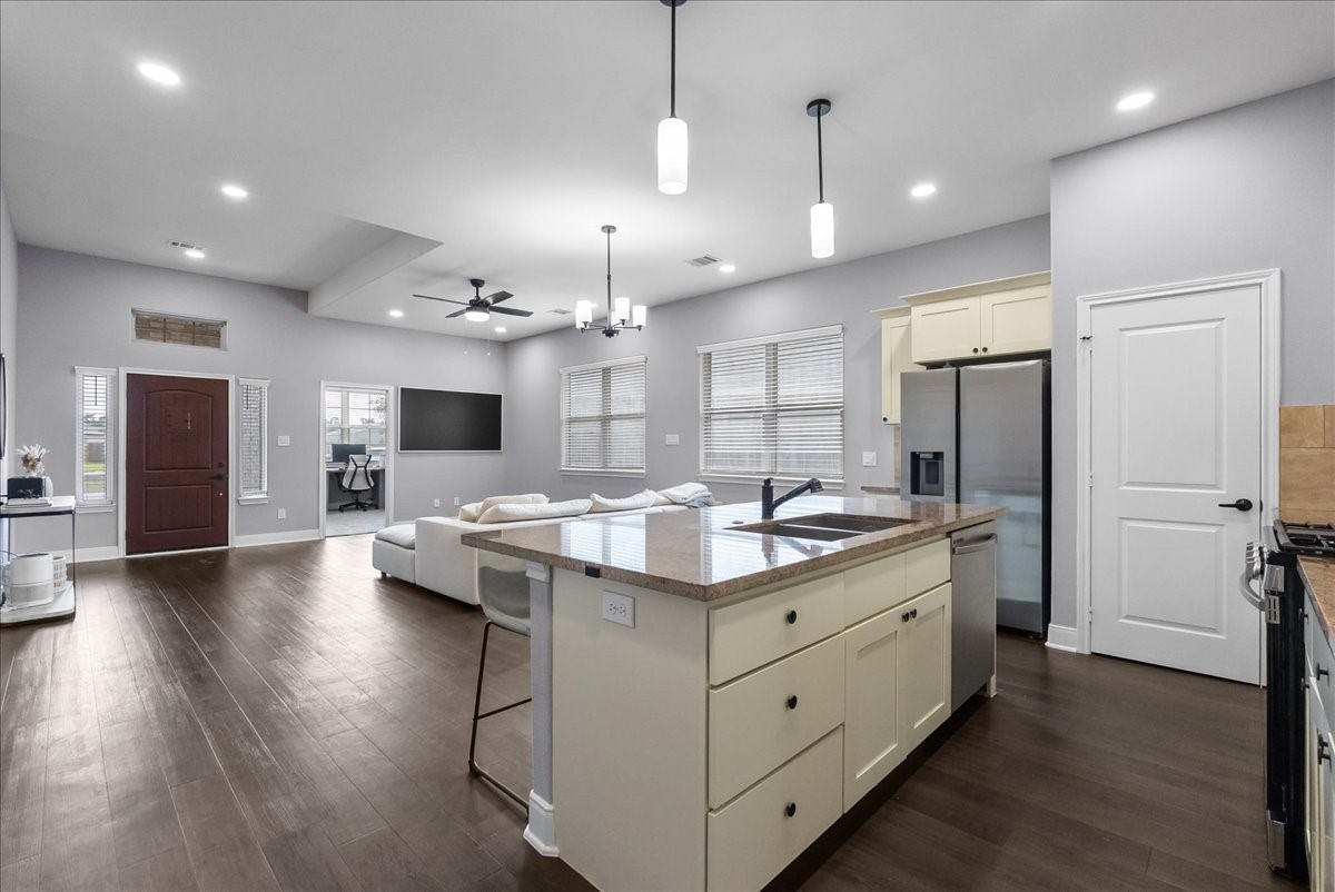 20061 Torrey Pines Lane Cleveland, TX 77327 - Photo 17 of 41 a kitchen with stainless steel appliances kitchen island hardwood floor sink and stove