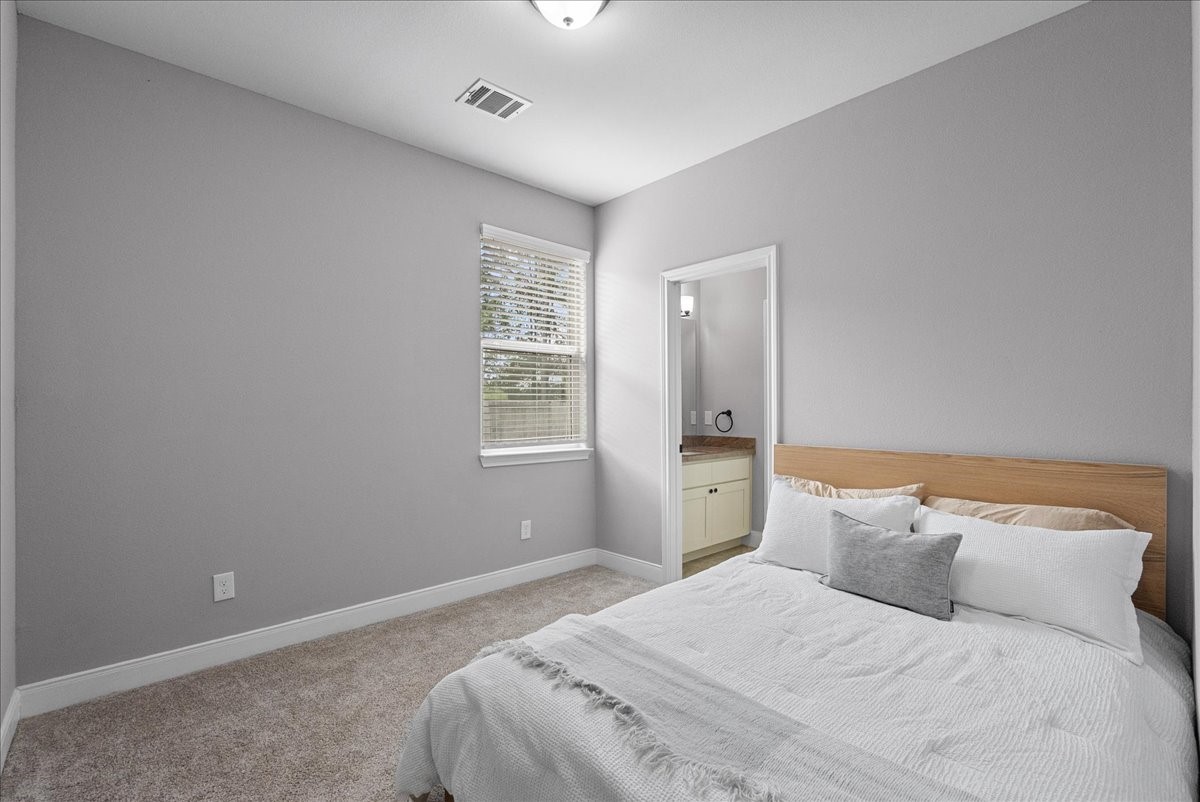 20061 Torrey Pines Lane Cleveland, TX 77327 - Photo 20 of 41 a bedroom with a bed and a window
