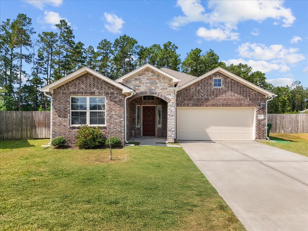 20061 Torrey Pines Lane Cleveland, TX 77327 - Photo 2 of 41 a front view of a house with yard and green space