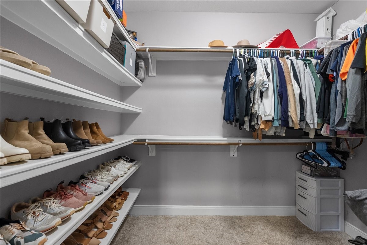 20061 Torrey Pines Lane Cleveland, TX 77327 - Photo 30 of 41 a view of walk in closet with clothes and shoes
