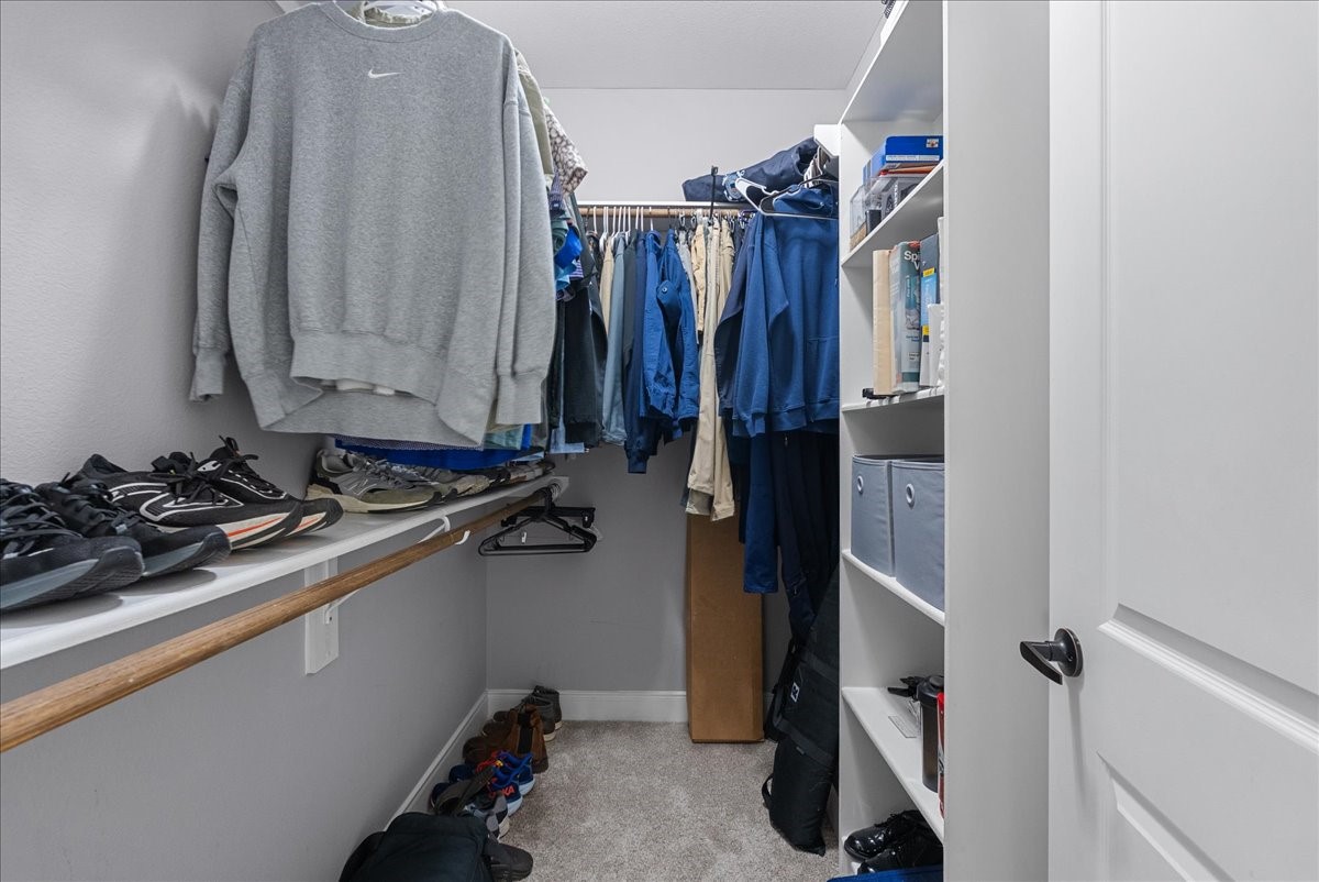 20061 Torrey Pines Lane Cleveland, TX 77327 - Photo 31 of 41 a view of walk in closet with clothes and shoes