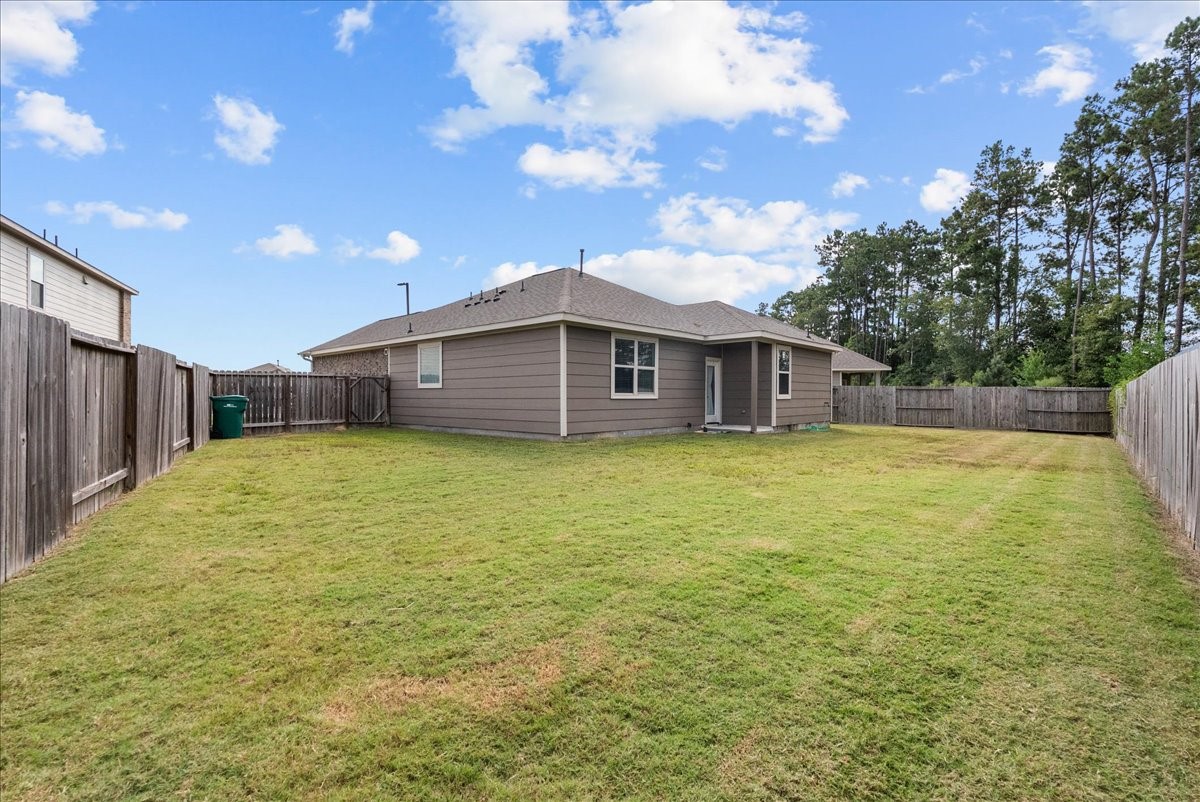 20061 Torrey Pines Lane Cleveland, TX 77327 - Photo 34 of 41 a view of a house with a backyard