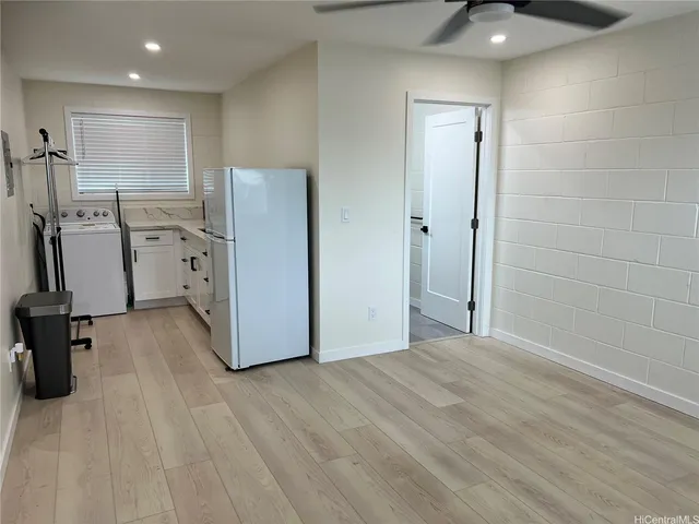 a view of a kitchen with a sink and a refrigerator