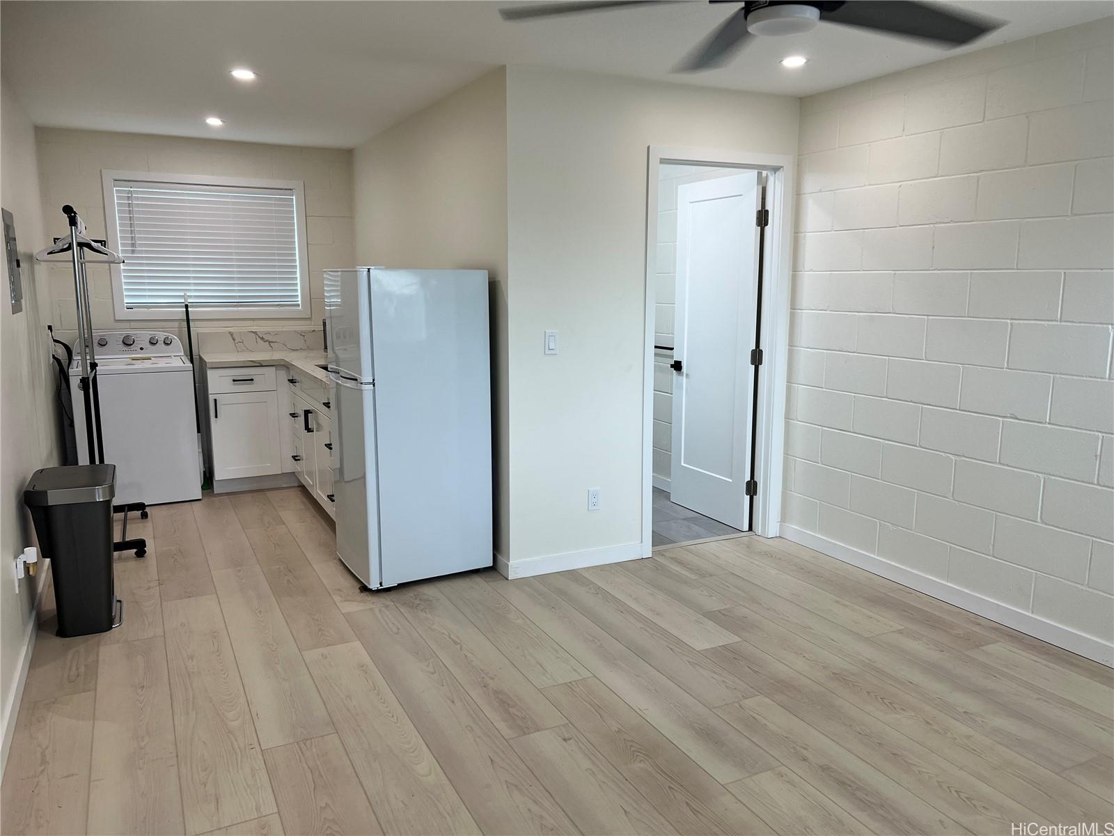 a view of a kitchen with a sink and a refrigerator