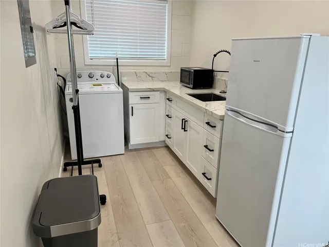 a view of a kitchen with refrigerator and washer