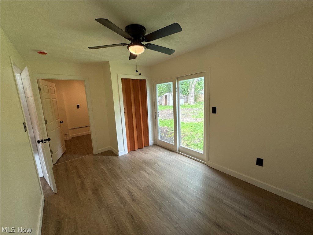 4841 Marigold Road Mentor, OH 44060 - Photo 6 of 12 Spacious room featuring wood-finish flooring, a contemporary ceiling fan, and sliding glass doors leading to the exterior