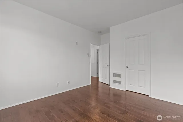 a view of an empty room and wooden floor