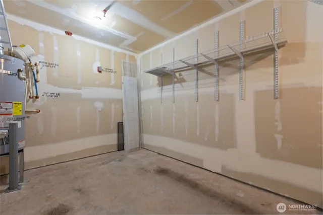 an aerial view of a city with lots of residential buildings ocean and mountain view in back