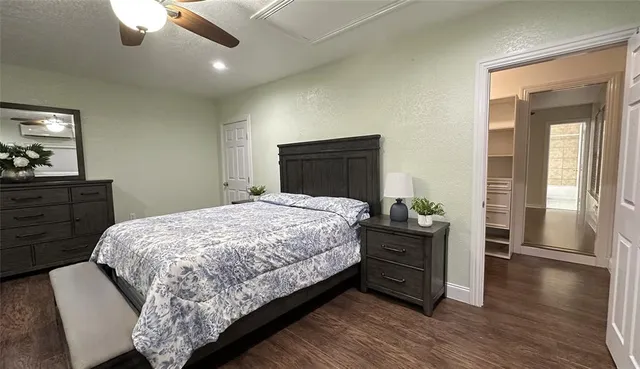 a bedroom with a bed and cabinet