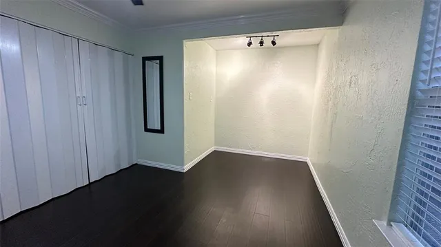 a view of an empty room with a ceiling fan