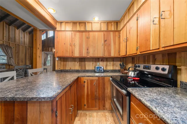 a kitchen with stainless steel appliances granite countertop a sink a counter space and cabinets