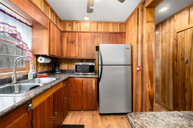 a kitchen with stainless steel appliances granite countertop a refrigerator a sink and dishwasher