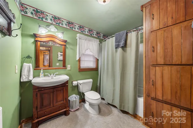 a bathroom with a toilet a sink and a mirror