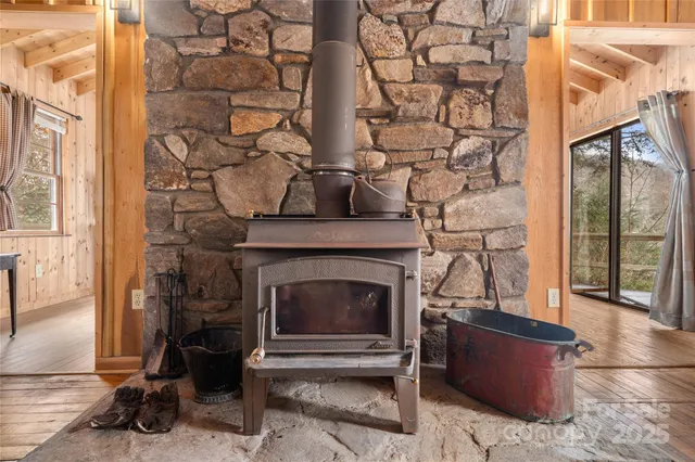a living room with a fireplace and a floor to ceiling window