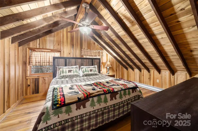 a bed sitting in a bedroom next to a window