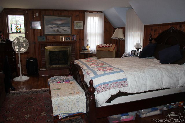 391 Haven Beach Road Moon, VA 23119 - Photo 18 of 43 a bedroom with a bed and a fireplace
