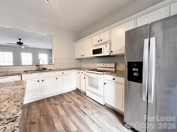 a kitchen with stainless steel appliances a refrigerator sink and microwave
