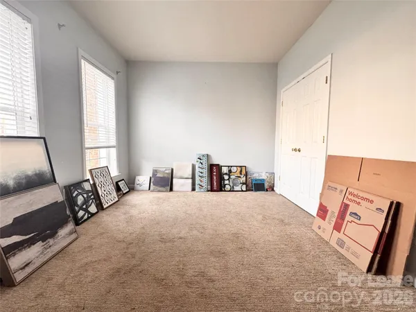 a large bed sitting in a bedroom next to a window