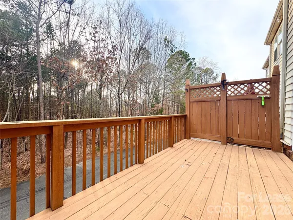 a view of balcony with wooden floor and fence