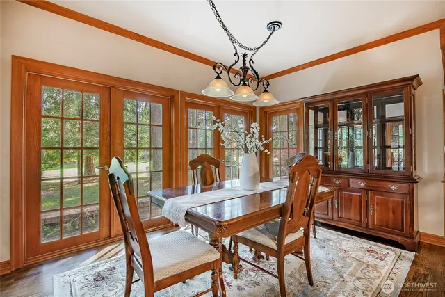 a view of a dining room with furniture wooden floor and chandelier