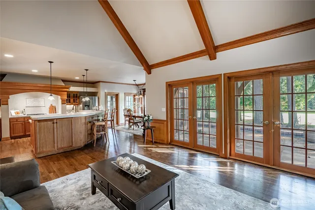 a living room with furniture and a floor to ceiling window
