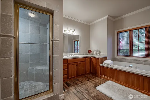 a spacious bathroom with double vanity and a bathtub
