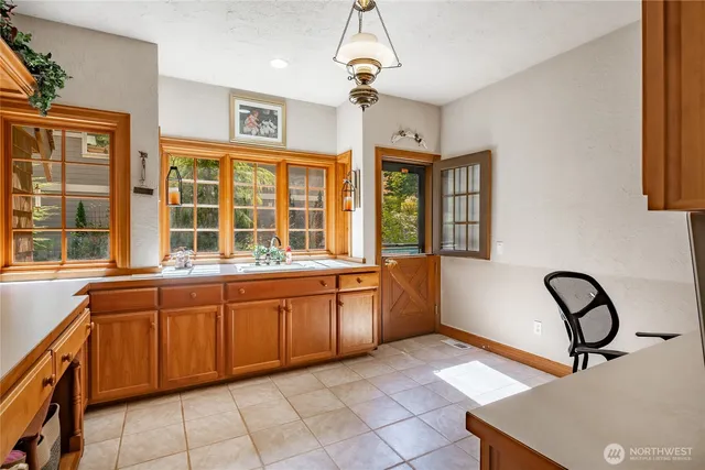 a large kitchen with stainless steel appliances granite countertop a stove and a sink next to a window