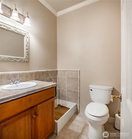 a bathroom with a sink toilet and mirror