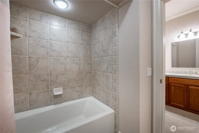 a bath tub sitting next to a bathroom sink