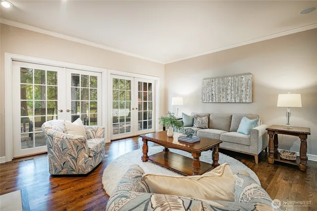 a living room with furniture and floor to ceiling windows