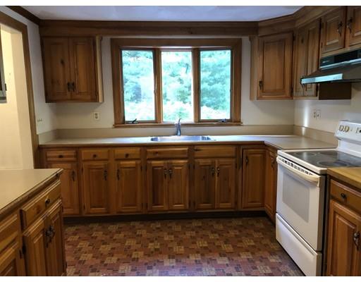 78 Draper Road Wayland, MA 01778 - Photo 4 of 10 a kitchen with stainless steel appliances granite countertop a sink stove and cabinets
