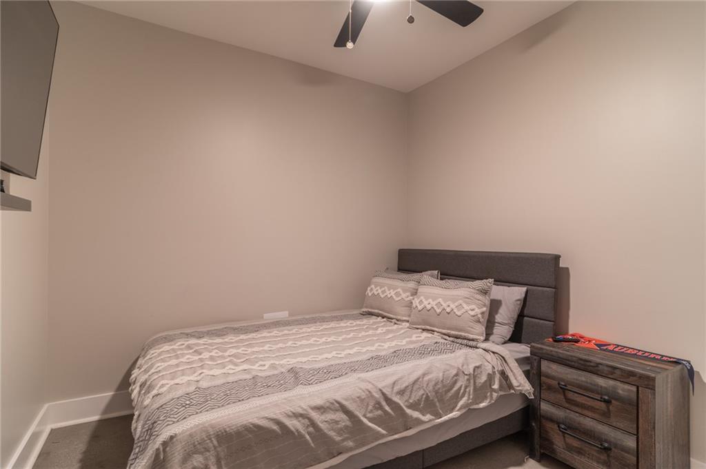 2250 Sperin Road Ball Ground, GA 30107 - Photo 32 of 56 a bedroom with a bed and a ceiling fan
