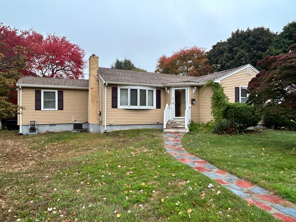 a backyard of a house with table and chairs