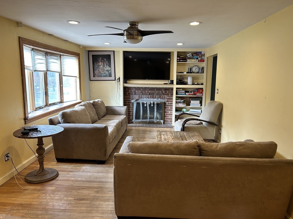 27 Evans Road Stoneham, MA 02180 - Photo 3 of 10 a living room with furniture and a flat screen tv