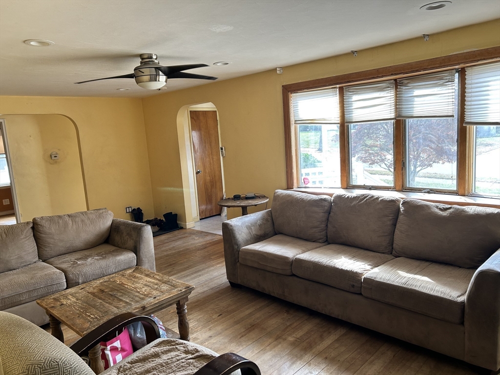 27 Evans Road Stoneham, MA 02180 - Photo 4 of 10 a living room with furniture and a large window