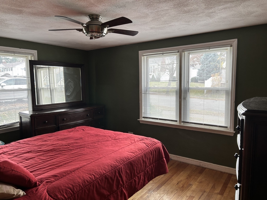 27 Evans Road Stoneham, MA 02180 - Photo 8 of 10 a bed sitting in a bedroom next to a window