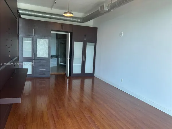 a view of hallway with wooden floor and stairs
