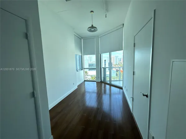 a view of hallway with wooden floor
