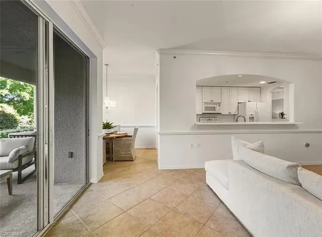 a kitchen with white cabinets and counter space