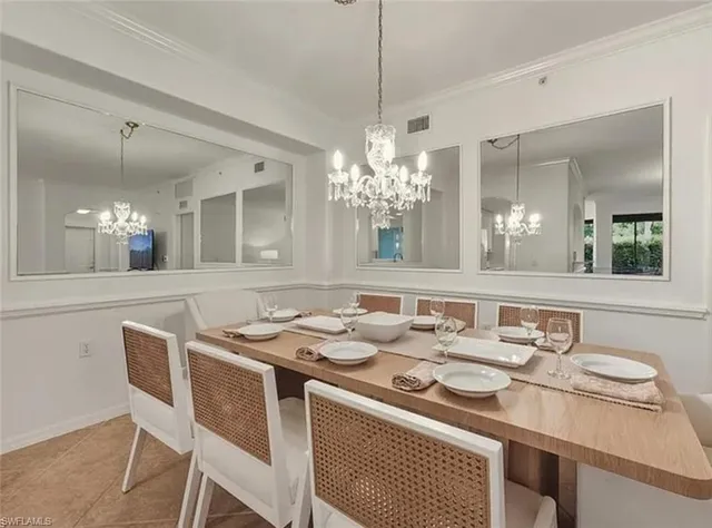 a dining room with a table and chairs