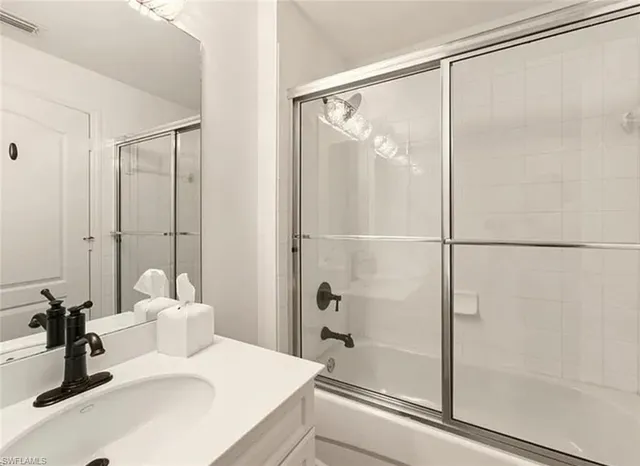 a bathroom with a sink and shower