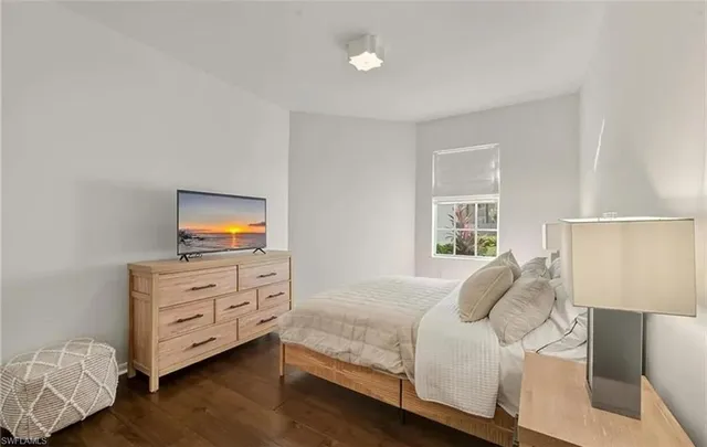 a bedroom with a bed and a television