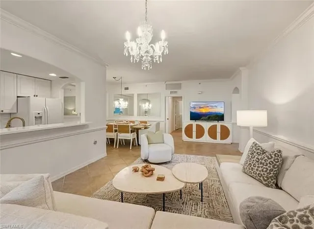 a living room with furniture and a chandelier
